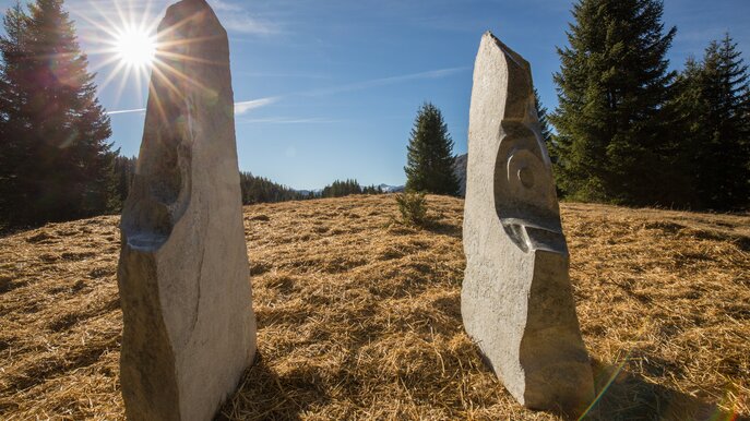 Zwei Steinskulpturen am Six Senses-Weg in Serfaus-Fiss-Ladis, im Hintergrund Wiesen, Bäume und strahlender Sonnenschein | © Serfaus-Fiss-Ladis Marketing GmbH | Andreas Kirschner