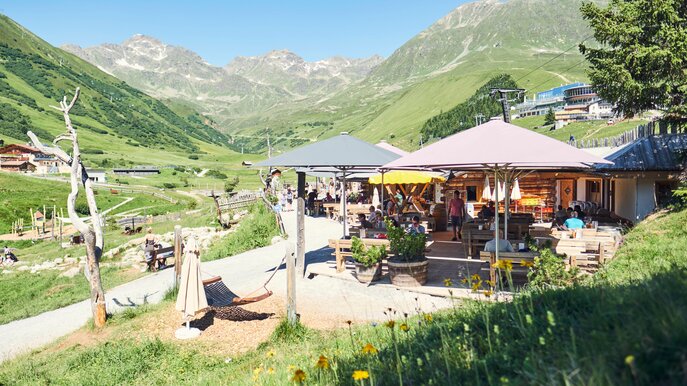 Gäste genießen sonniges Wetter auf der Terrasse des Leithe Wirt in Serfaus mit Blick auf das idyllische Bergpanorama | © Serfaus-Fiss-Ladis Marketing GmbH