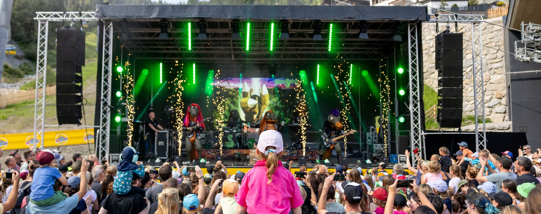 Die Band Heavysaurus tritt live auf der Bühne beim Mounds Festival 2024 in den Bergen auf, während das Publikum begeistert mitfeiert. | © Serfaus-Fiss-Ladis Marketing GmbH | Fabian Schirgi