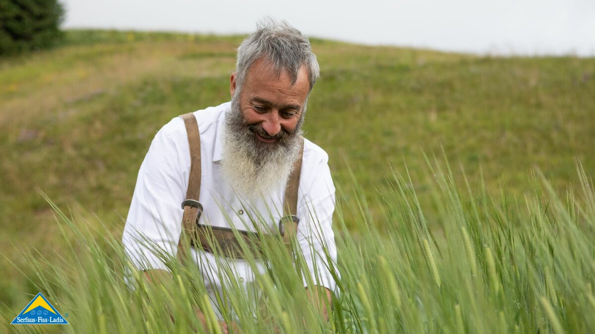Bauern in einem Getreidefeld in der Familienregion Serfaus-Fiss-Ladis Fisser Imperial Gerste | © Serfaus-Fiss-Ladis Marketing GmbH | Andreas Kirschner