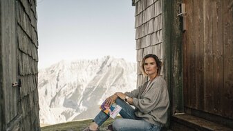 Autorin Monika Schmiderer mit ihrem Buch Switch off in den Bergen von Serfaus-Fiss-Ladis in Tirol | © Mike Rabensteiner